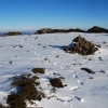 The cairn on the broad summit of Mt Clear in the snow.