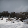 The horseyard at Tawonga Huts in winters snow lit by a single ray of sunshine. But more snow on the way - much more!